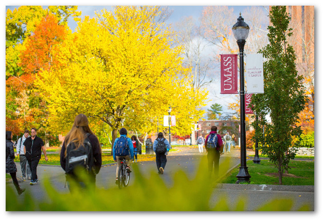 Students waling along campus mall in fall